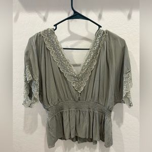 Women’s flowy light green lace top.
